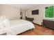 Well-lit bedroom boasts a sleek bed, hardwood floors, and modern furniture at 3385 Rainbow Dr # 7A, Marvin, NC 28173