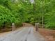 Private gravel driveway surrounded by lush, mature trees leads to a serene retreat at 3385 Rainbow Dr # 7A, Marvin, NC 28173