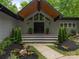 Stunning front entrance with stone accents, a modern roofline, and lush landscaping for excellent curb appeal at 3385 Rainbow Dr # 7A, Marvin, NC 28173