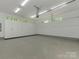 Spacious garage with white cabinets, grey epoxy floors, and modern lighting at 3385 Rainbow Dr # 7A, Marvin, NC 28173