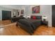 Bedroom featuring hardwood floors, a black bed, closet, and a large mirror with painting at 3385 Rainbow Dr # 7A, Marvin, NC 28173