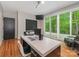 Bright office space with hardwood floors, modern lighting, desk, and sliding glass doors to outdoor deck at 3385 Rainbow Dr # 7A, Marvin, NC 28173