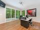 Bright office space with hardwood floors, modern lighting, desk, and sliding glass doors to outdoor deck at 3385 Rainbow Dr # 7A, Marvin, NC 28173