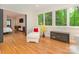 Bright sunroom with hardwood floors, comfortable seating, and expansive windows with forest views at 3385 Rainbow Dr # 7A, Marvin, NC 28173