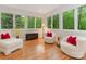 Sunroom filled with natural light and comfortable seating, overlooking a serene wooded area at 3385 Rainbow Dr # 7A, Marvin, NC 28173