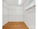 Walk-in closet featuring ample storage with built-in shelving and hardwood flooring at 3385 Rainbow Dr # 7A, Marvin, NC 28173