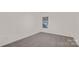 A carpeted bedroom with a window letting in natural light shows a minimalistic design at 356 Bly St, Rock Hill, SC 29732