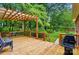 Inviting back deck featuring a pergola, railing, and outdoor grill, perfect for entertaining at 3804 Bellingham Ln, Charlotte, NC 28215
