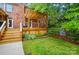Charming backyard featuring a multi-level deck, lush landscaping, and a brick exterior at 3804 Bellingham Ln, Charlotte, NC 28215