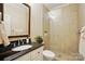 Updated bathroom with tiled shower, modern vanity, and ample lighting at 3804 Bellingham Ln, Charlotte, NC 28215