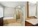 Modern bathroom showcasing a glass shower and separate soaking tub with neutral tile and granite vanity at 3804 Bellingham Ln, Charlotte, NC 28215