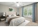 Inviting bedroom with a bright window, soft textures, and calm, neutral color palette at 3804 Bellingham Ln, Charlotte, NC 28215