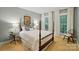 Charming bedroom with a four-poster bed, soft lighting, and serene views from the windows at 3804 Bellingham Ln, Charlotte, NC 28215