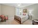Cozy bedroom with classic wood bed frame, window and chair in a calming color palette at 3804 Bellingham Ln, Charlotte, NC 28215