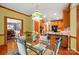 Inviting dining room boasts a glass table, wood floors, and decorative lighting at 3804 Bellingham Ln, Charlotte, NC 28215