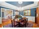 Dining room featuring blue walls, a wood table, and stylish chandelier at 3804 Bellingham Ln, Charlotte, NC 28215