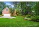 Stunning brick home featuring a well-maintained lawn, mature trees, and a two-car garage at 3804 Bellingham Ln, Charlotte, NC 28215