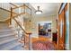 Spacious foyer featuring hardwood floors, staircase, and dining room view at 3804 Bellingham Ln, Charlotte, NC 28215