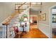 Elegant foyer with hardwood floors, staircase, and view of the living room with fireplace at 3804 Bellingham Ln, Charlotte, NC 28215