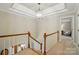 Hallway with coffered ceiling and modern chandelier that leads to rooms with carpeted floors at 3804 Bellingham Ln, Charlotte, NC 28215