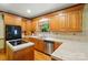 Well-lit kitchen features stainless steel appliances, tile countertops, and wood cabinetry at 3804 Bellingham Ln, Charlotte, NC 28215