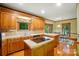 Spacious kitchen area showcases an island cooktop, breakfast nook, and wooden cabinets at 3804 Bellingham Ln, Charlotte, NC 28215