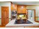 Kitchen island has a countertop cooktop and built in oven and microwave at 3804 Bellingham Ln, Charlotte, NC 28215
