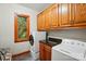 Well-equipped laundry room featuring modern washer and dryer units and ample cabinet space at 3804 Bellingham Ln, Charlotte, NC 28215
