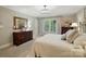Spacious main bedroom features a large window with view, neutral colors, and wood dresser at 3804 Bellingham Ln, Charlotte, NC 28215