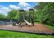 Community playground featuring a play structure with a slide, climbing areas, and green turf at 3804 Bellingham Ln, Charlotte, NC 28215