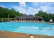 Inviting community pool with lounge chairs and tables under a covered area, perfect for relaxing on a sunny day at 3804 Bellingham Ln, Charlotte, NC 28215