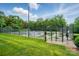 Well-maintained outdoor tennis courts enclosed by a black fence and surrounded by lush greenery at 3804 Bellingham Ln, Charlotte, NC 28215