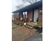 Charming front porch with brickwork, decorative railings, and flower accents on a landscaped lawn at 401 Clover Ln, Newton, NC 28658