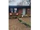 Inviting front porch with seating, floral arrangements, and well-maintained landscaping at 401 Clover Ln, Newton, NC 28658