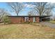 Charming brick home with a covered carport and a cozy front porch, set in a tranquil tree-lined neighborhood at 401 Clover Ln, Newton, NC 28658