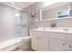 Bright bathroom with a glass-enclosed shower, white vanity with double sinks, and modern fixtures at 413 River Park Rd, Belmont, NC 28012