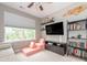 Comfortable bedroom with a window view, media center, and cozy seating, perfect for relaxation at 413 River Park Rd, Belmont, NC 28012
