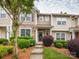Charming townhome featuring stone accents, landscaped front yard, and inviting curb appeal at 413 River Park Rd, Belmont, NC 28012