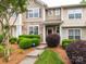 Charming townhome with stone accents, a manicured lawn, and tasteful landscaping at 413 River Park Rd, Belmont, NC 28012