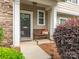 Inviting front porch with a bench and stylish decor, creating a cozy entryway to the home at 413 River Park Rd, Belmont, NC 28012