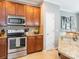 A kitchen featuring stainless steel appliances, granite countertops, and wooden cabinetry at 413 River Park Rd, Belmont, NC 28012