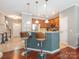 Stylish kitchen with breakfast bar seating, stainless steel appliances, and warm wood cabinetry at 413 River Park Rd, Belmont, NC 28012
