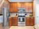 A kitchen featuring stainless steel appliances, granite countertops, and wooden cabinetry at 413 River Park Rd, Belmont, NC 28012