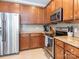 A kitchen featuring stainless steel appliances, granite countertops, and wooden cabinetry at 413 River Park Rd, Belmont, NC 28012