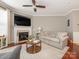 Cozy living room with a fireplace, hardwood floors, comfortable sofa and a stylish coffee table at 413 River Park Rd, Belmont, NC 28012