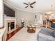 Comfortable living room featuring a fireplace, hardwood floors, and open-concept design to the kitchen at 413 River Park Rd, Belmont, NC 28012