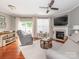 Bright living room with hardwood floors, a fireplace, a ceiling fan, and a comfortable seating area at 413 River Park Rd, Belmont, NC 28012