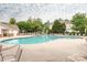 Large community pool surrounded by lounge chairs and mature trees, perfect for summer enjoyment at 413 River Park Rd, Belmont, NC 28012