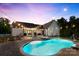 Backyard pool with connected spa, lounge chairs, and a well-manicured lawn at twilight at 4453 Buffalo Shoals Rd, Maiden, NC 28650