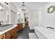 Bathroom with dual sink vanity, standalone tub, and walk-in closet at 4453 Buffalo Shoals Rd, Maiden, NC 28650
